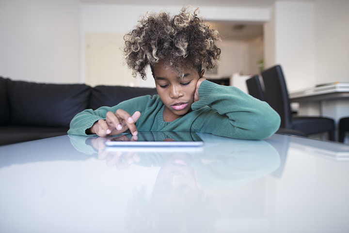 Child surfing internet on tablet computer.